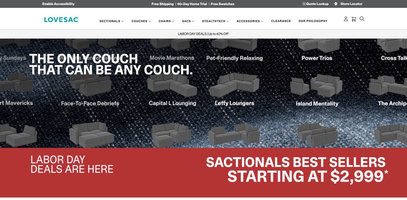 Original Lovesac homepage hero: dark textured background, promotional banner, and dense navigation.